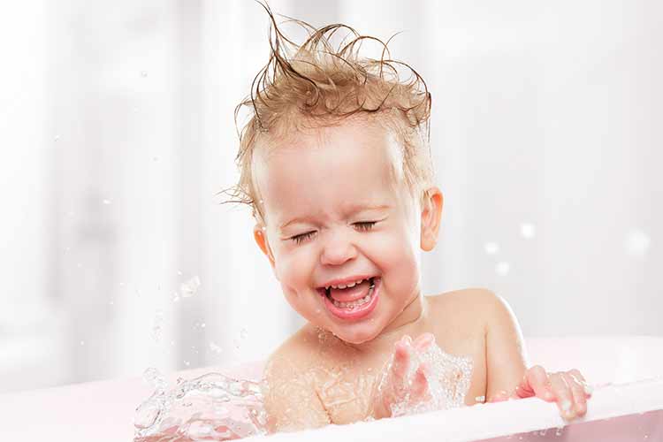 Laughing baby in tub