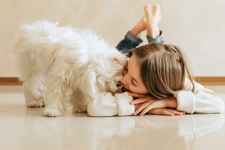 Dog and girl on floor